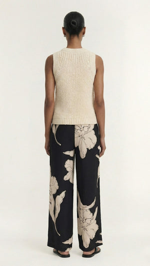 Model wearing Sketched Floral Drawstring Pant with beige sleeveless top from the back.