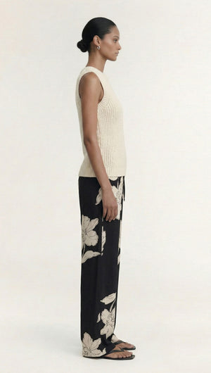 Model wearing Sketched Floral Drawstring Pant paired with a cream sleeveless top, showcasing a side view.