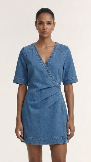 Cotton Denim Wrap Detail Mini Dress modeled by a woman, showcasing a stylish denim mini dress with wrap detail.