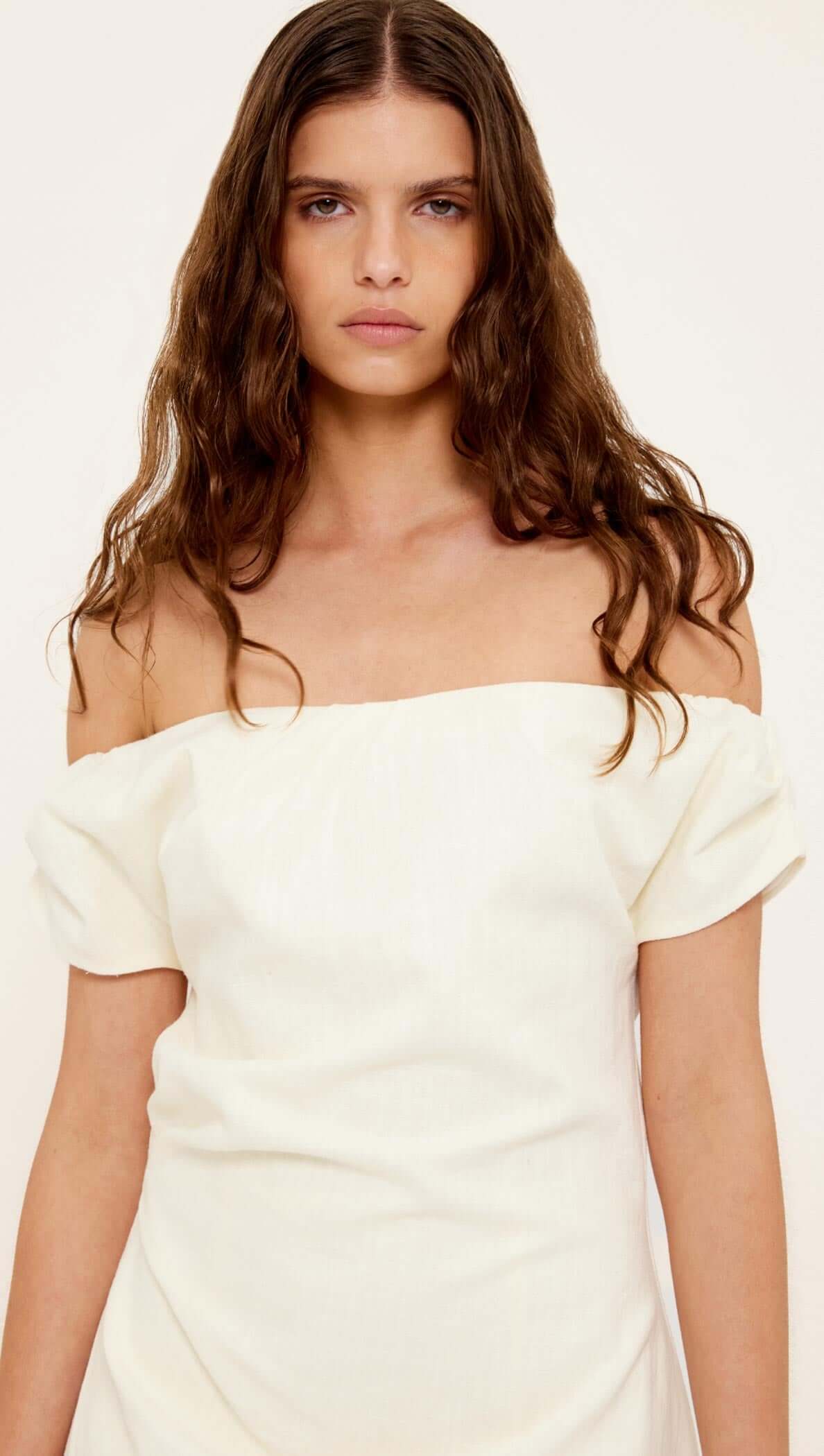 Linen Blend White Off-Shoulder Mini Dress featuring an off-shoulder neckline and short sleeves on a model.