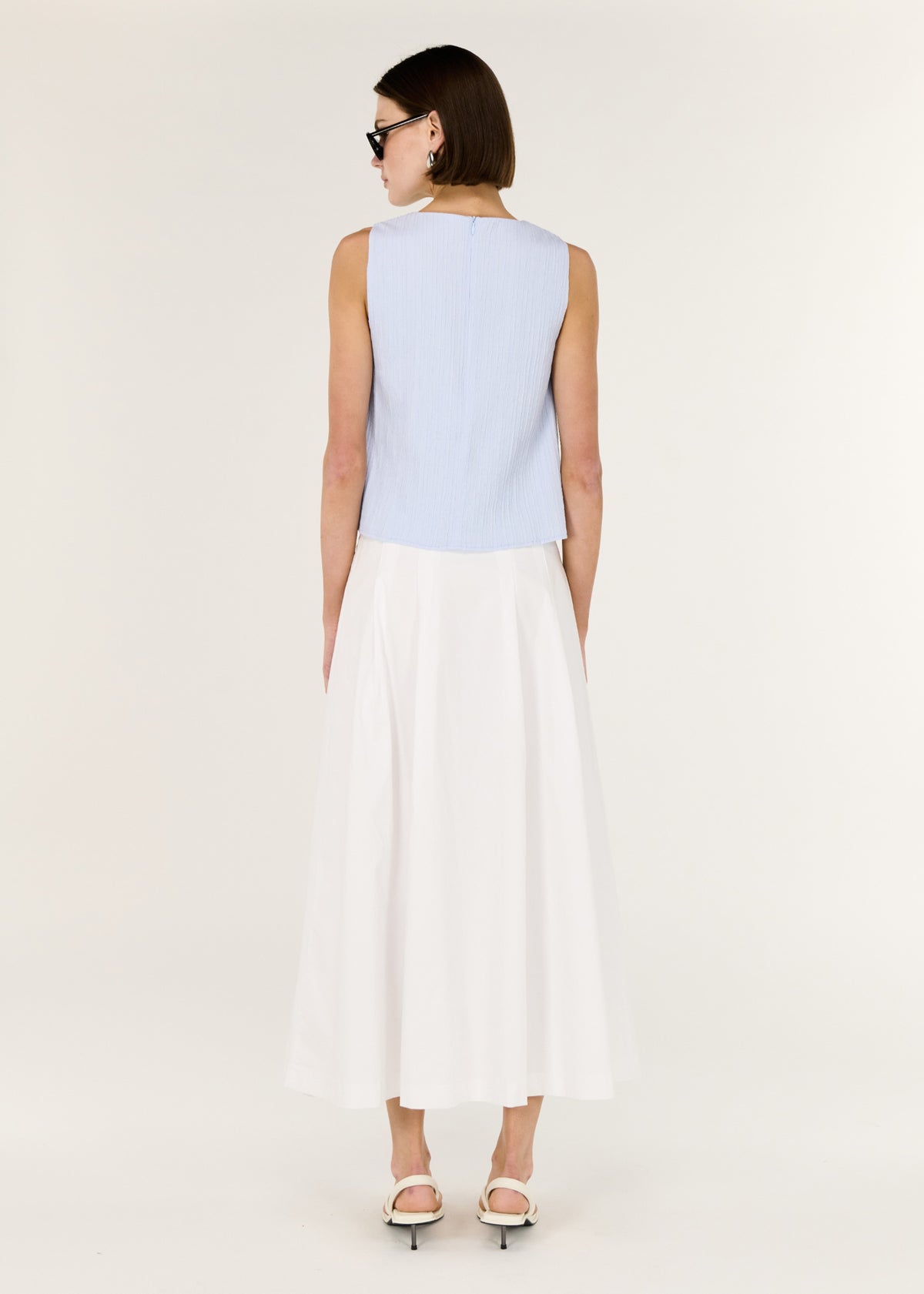 Back view of the A-Line White Cotton Maxi Skirt with a mid-rise waist fit and a maxi length silhouette.