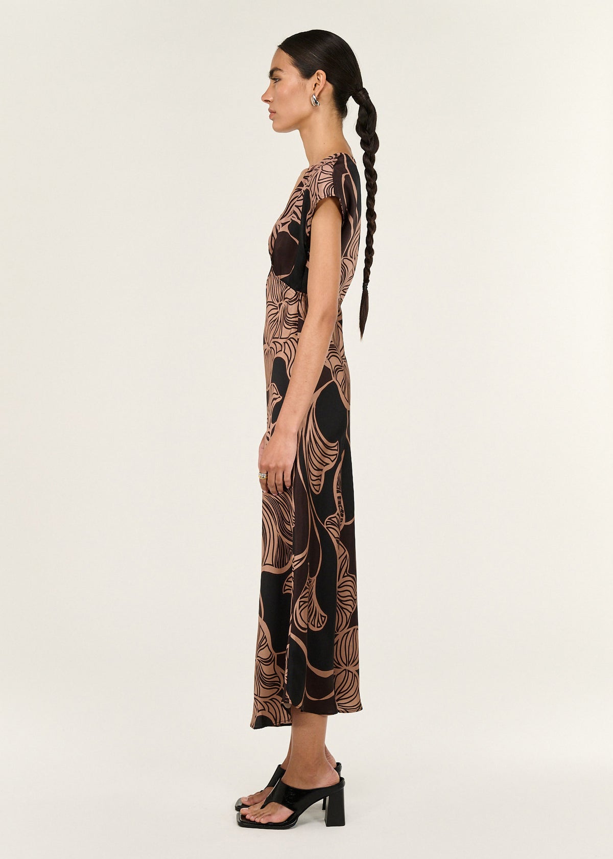 Side view of the Abstract Leaf Print Bias Cut Midi Dress, showing a soft drape and a soft V neckline.