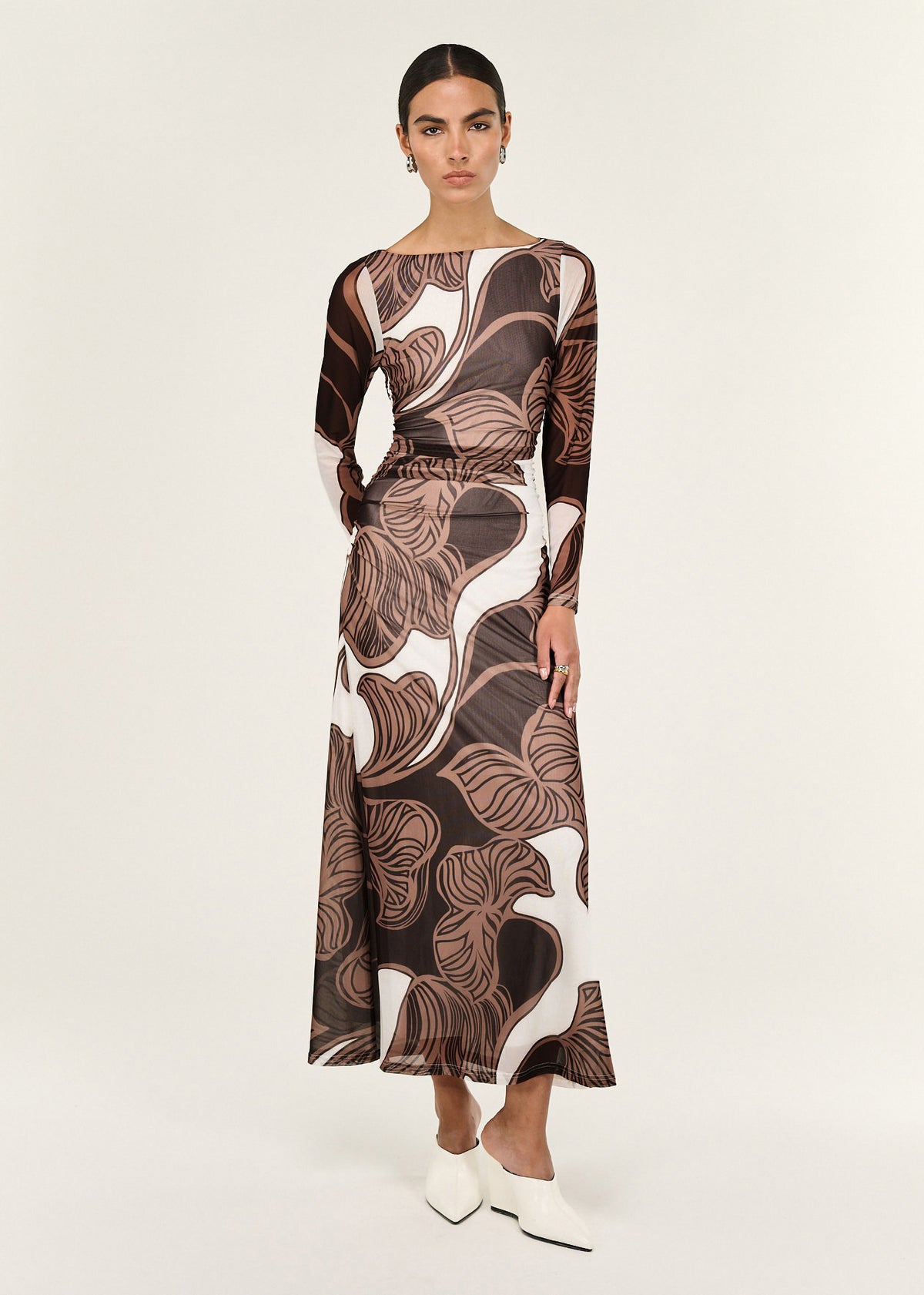 Model wearing Abstract Leaf Print Mesh Midi Dress with long sleeves and a sheer mesh fabrication with stretch.