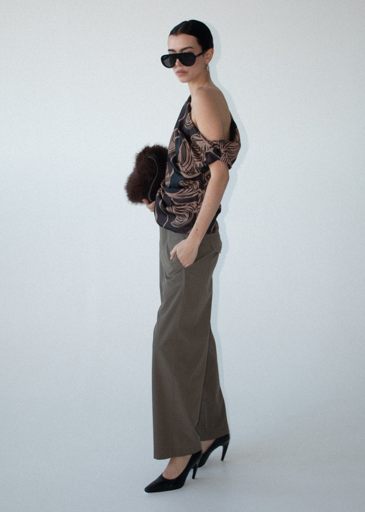 Side view of the Abstract Leaf Print One Shoulder Top, showing abstract leaf print in chocolate tones and a fluid drape.