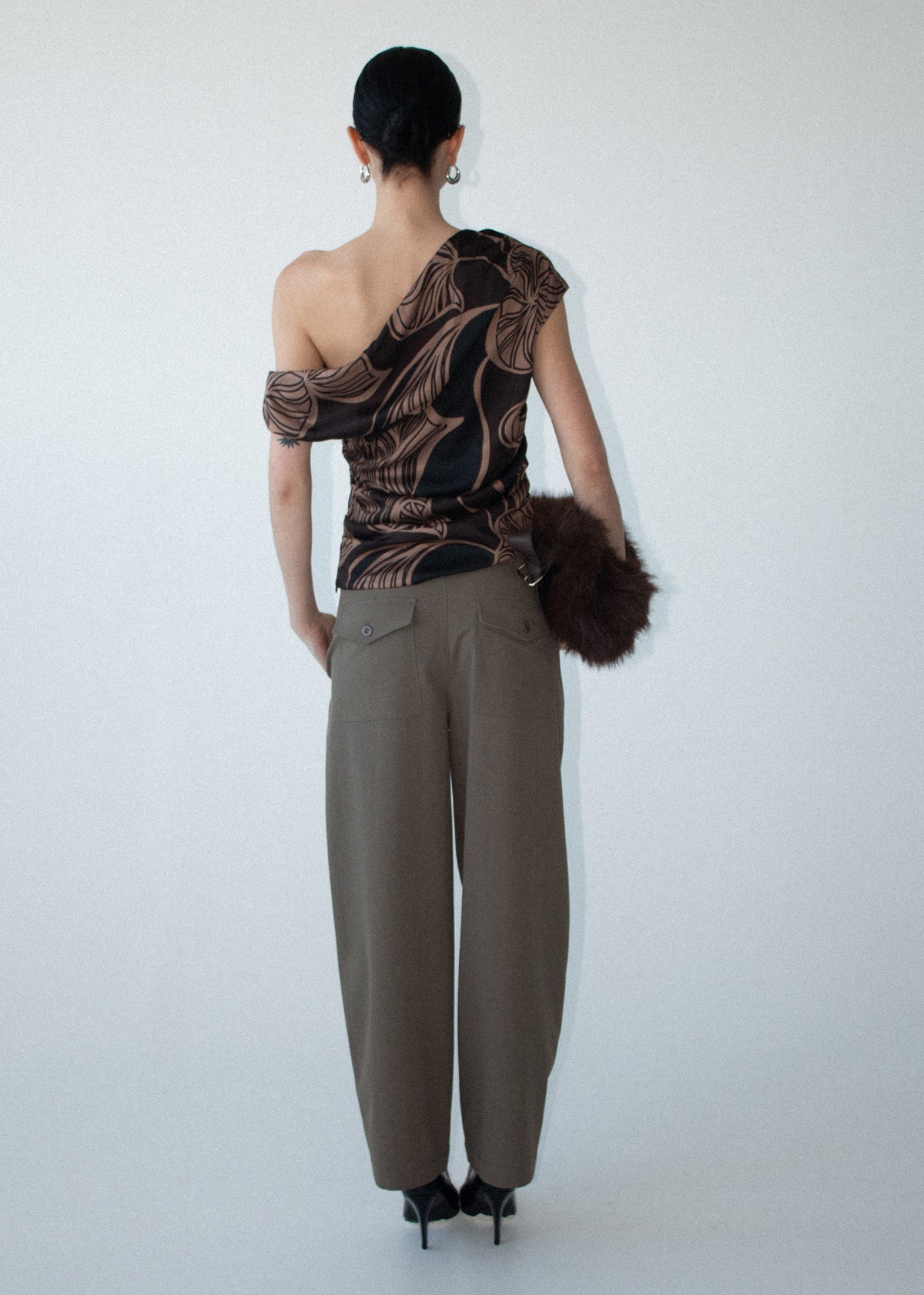 Back view of the Abstract Leaf Print One Shoulder Top with an asymmetric neckline with draped detail and a ruched body.