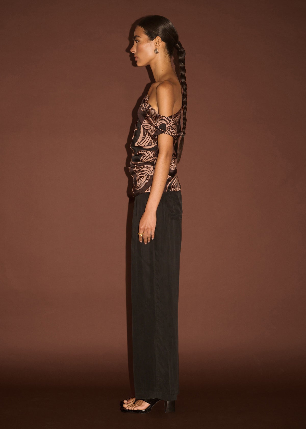 Side profile of the Abstract Leaf Print One Shoulder Top with an asymmetric neckline with draped detail and a ruched body.