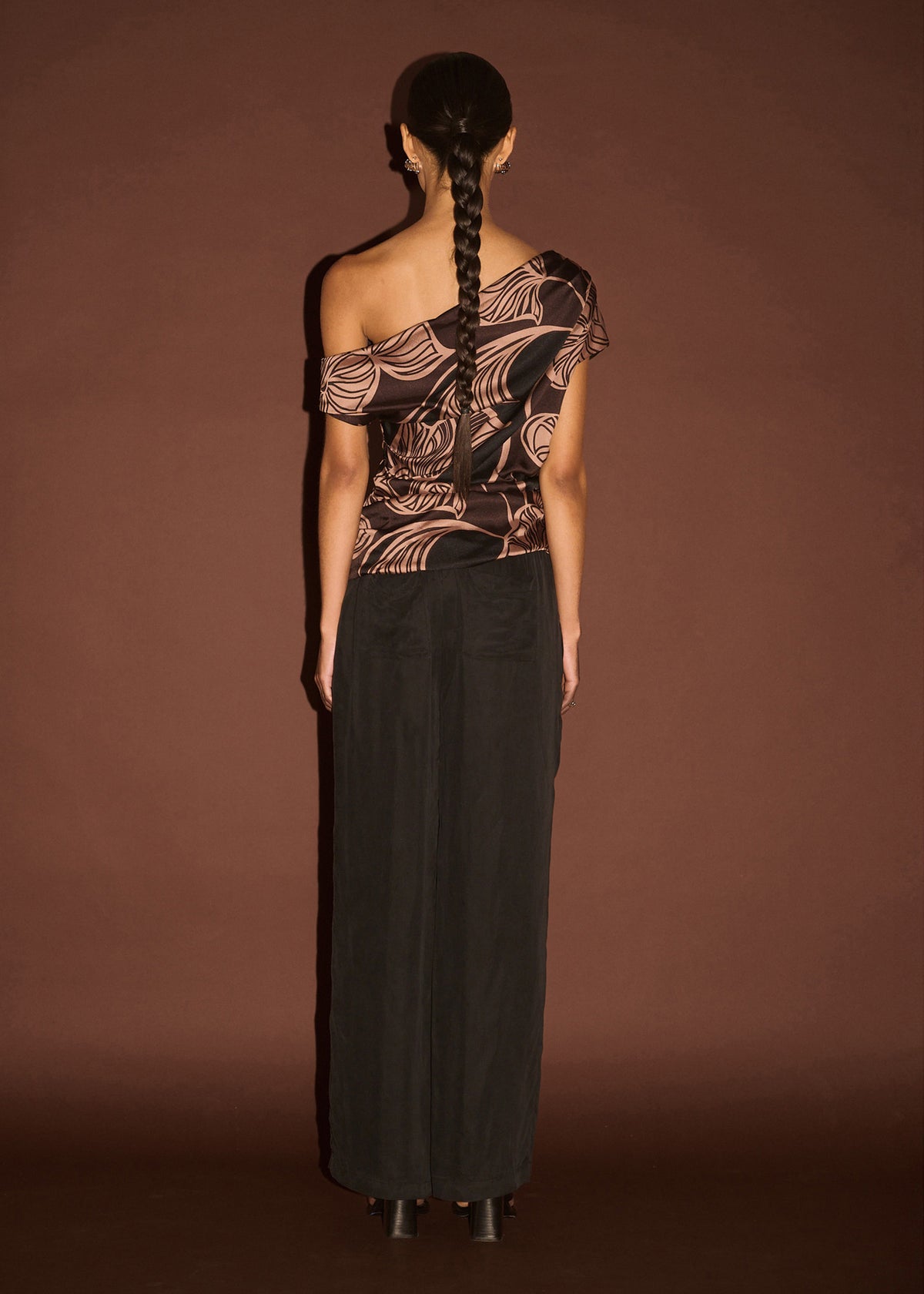 Back view of the Abstract Leaf Print One Shoulder Top, showing an asymmetric neckline with draped detail and a ruched body.