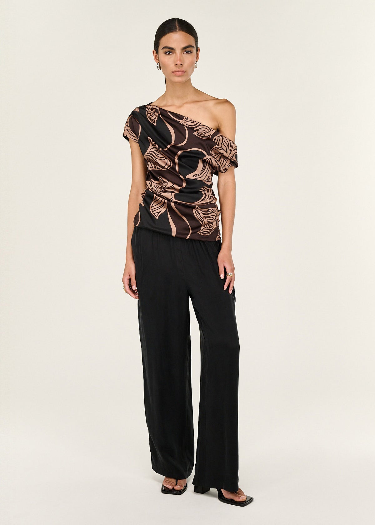 Model wearing Abstract Leaf Print One Shoulder Top with a ruched body and an asymmetric neckline with draped detail.