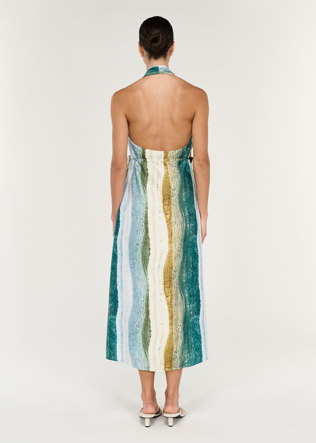 Back view of the Wrap Halter Midi Dress in Ocean Tide showcasing abstract coastal-inspired print and open back design.