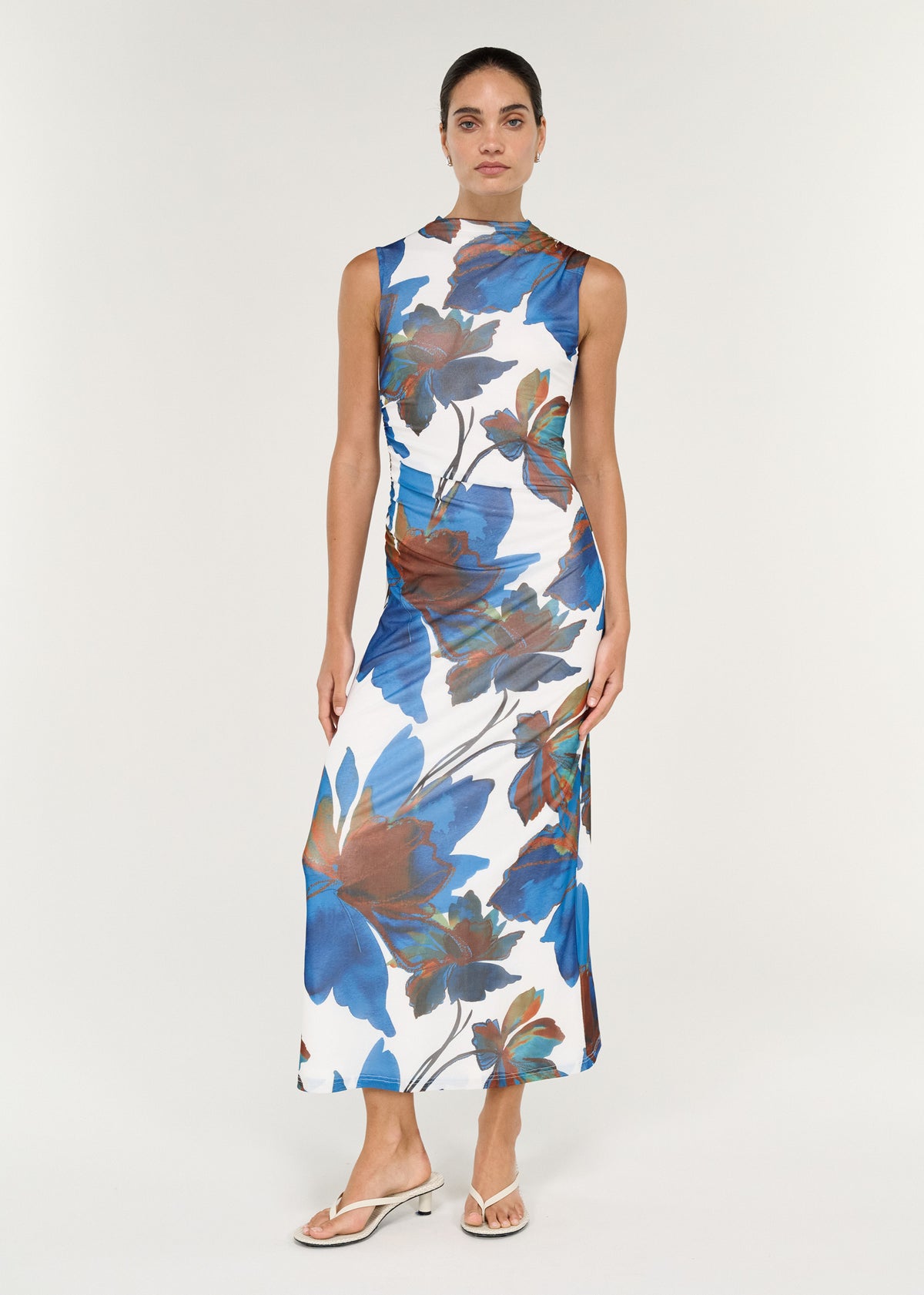 Sleeveless Mesh Midi Dress in Cobalt Floral displayed on a model, featuring a mock neckline and side split.