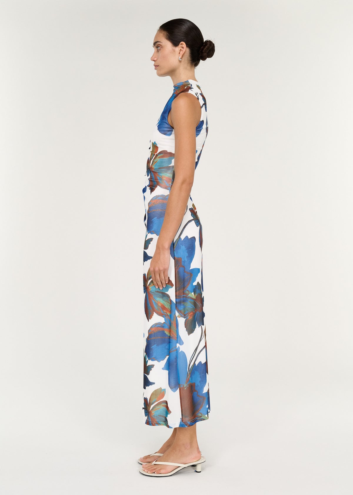 Sleeveless Mesh Midi Dress in Cobalt Floral worn by a model, showcasing the side view and floral print design.