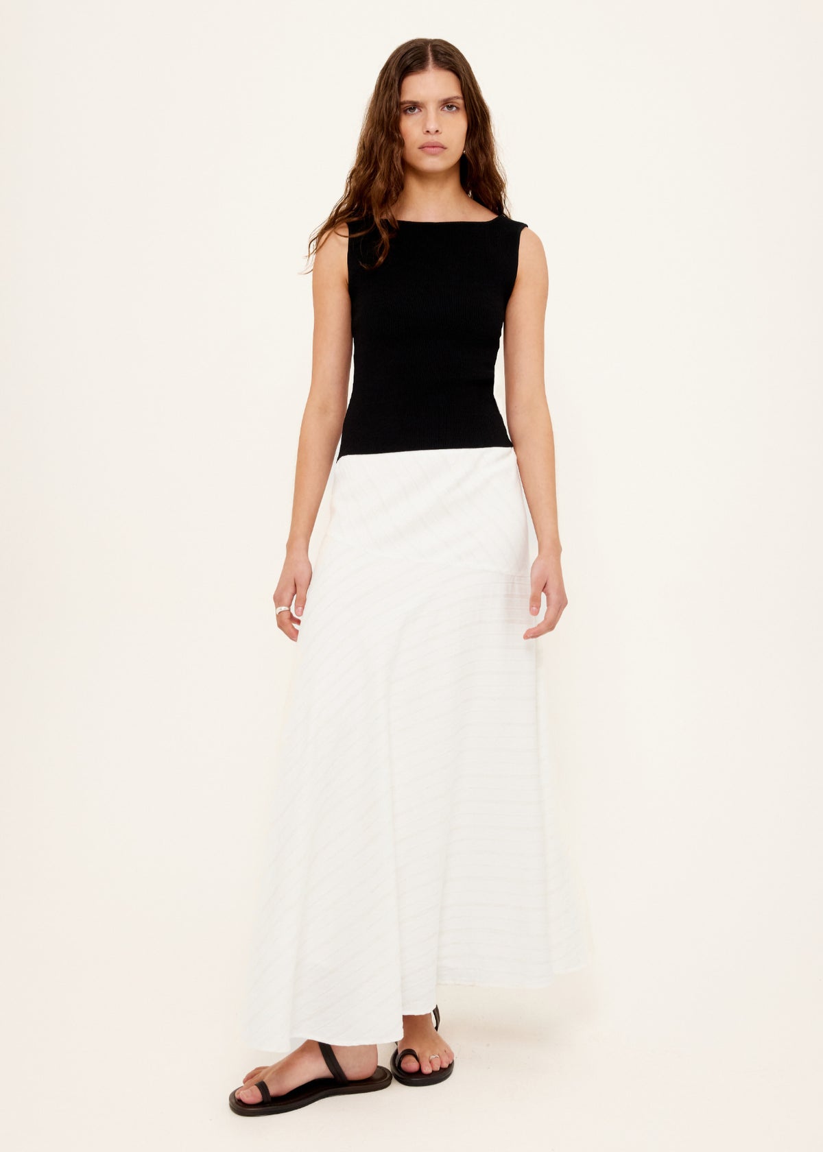 Model wearing Asymmetric White Bias Maxi Skirt with an asymmetric waistband detail and a bias-cut silhouette.
