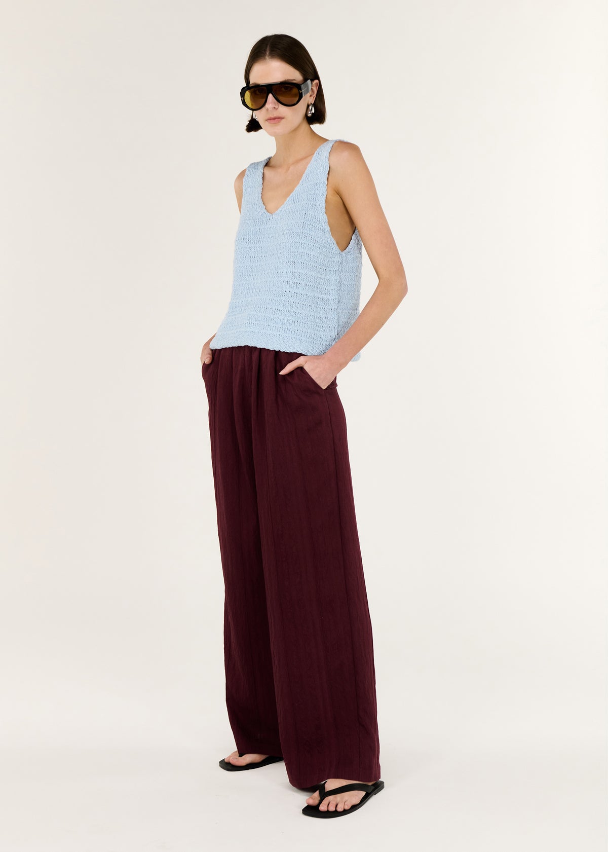 Model wearing Baby Blue Cotton Knit Tank with a lightweight and breathable, turned to the side.