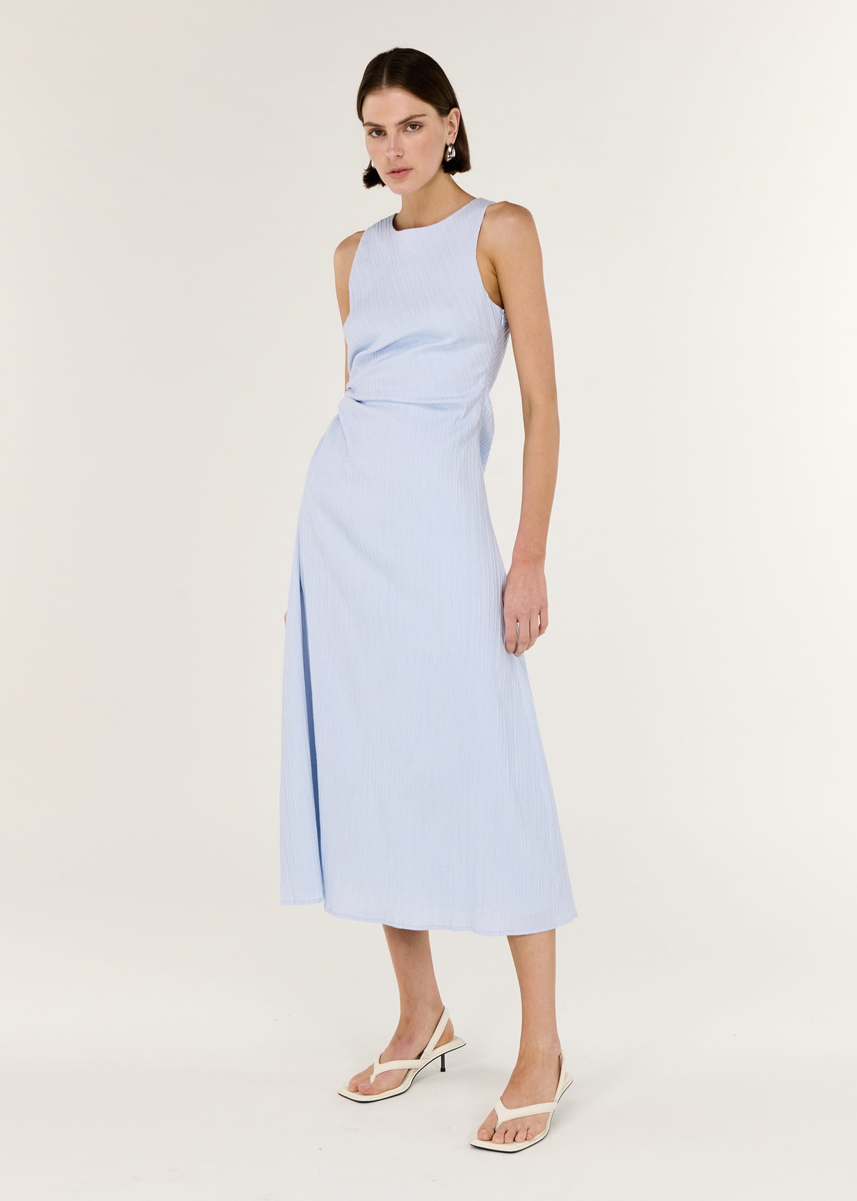 Model wearing Baby Blue Cotton Textured Cut Out Midi Dress with a sleeveless midi silhouette and a subtle side cut-out detail.