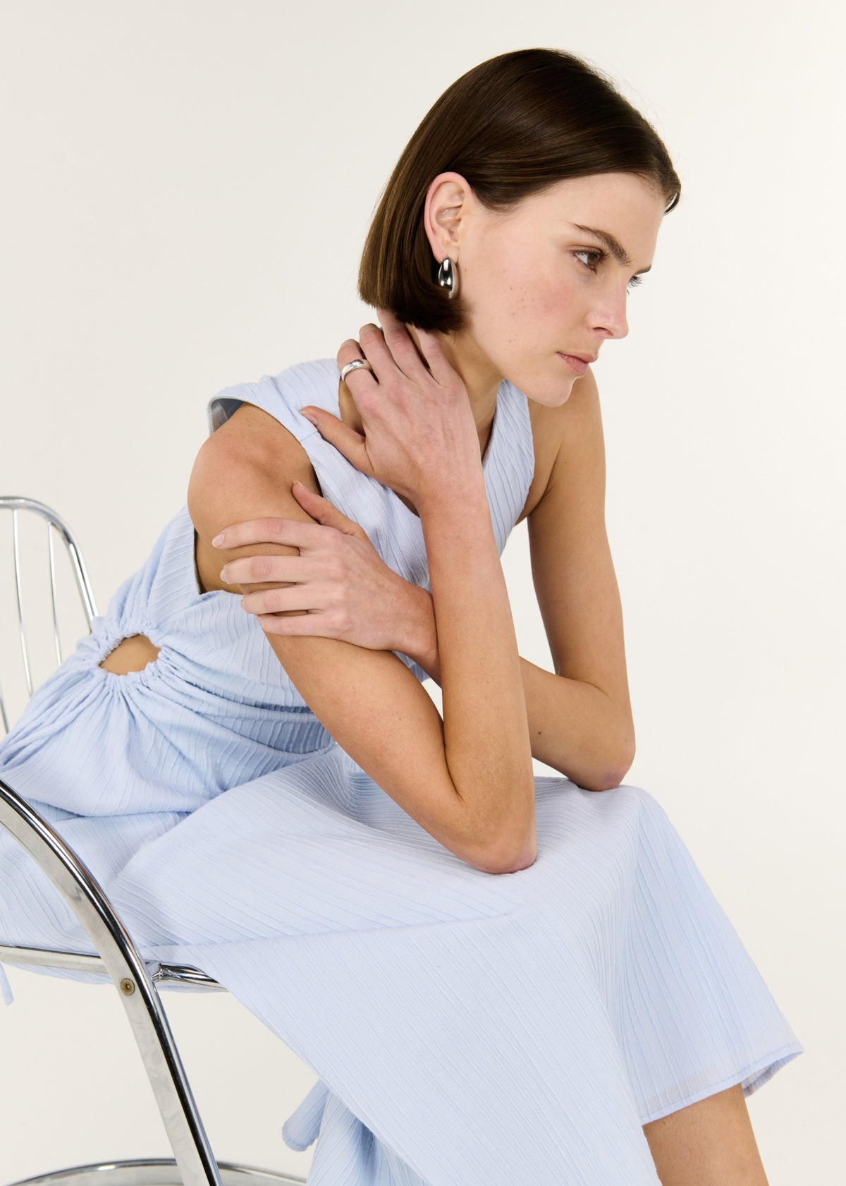Model posed wearing Baby Blue Cotton Textured Cut Out Midi Dress, showing a fully lined and a colour: Baby Blue.