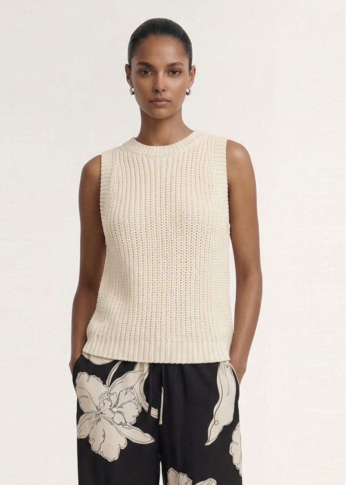 Close-up of the Beige Sleeveless Knit Tank Top, showing a sleeveless silhouette and a crew neckline.