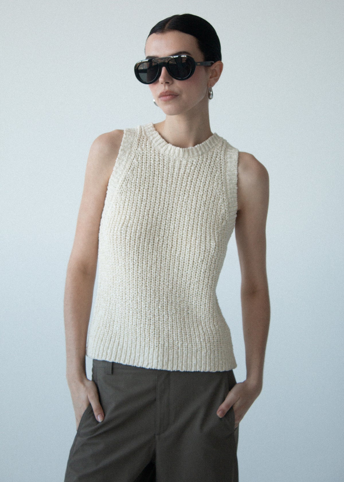 Close-up of Beige Sleeveless Knit Tank Top with a sleeveless silhouette and a crew neckline.