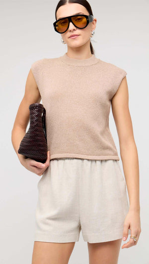 Beige Sleeveless Knit Top styled with tailored linen shorts and accessories.