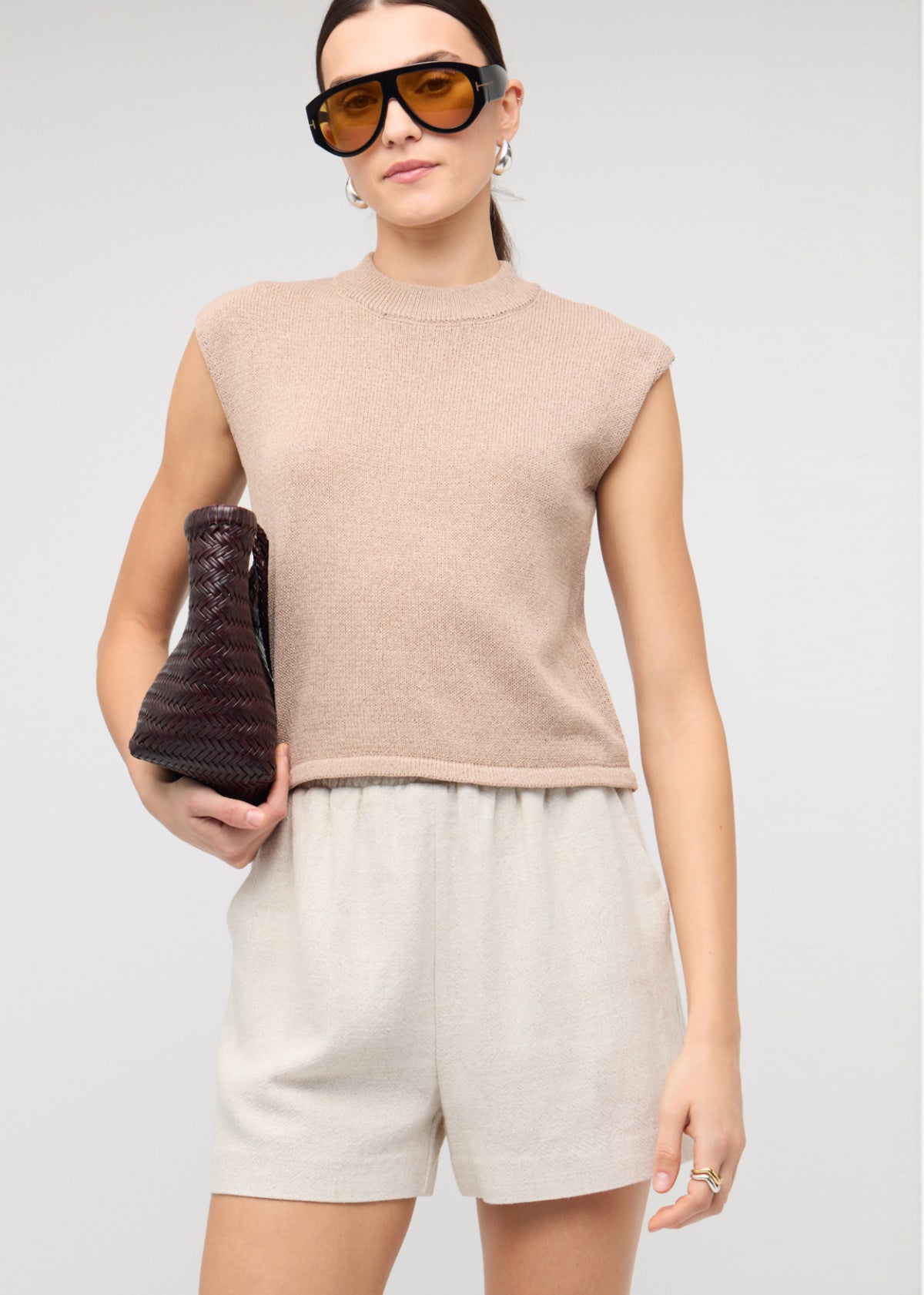 Close-up of the Beige Sleeveless Knit Top, showing a sleeveless cut and a crew neckline.