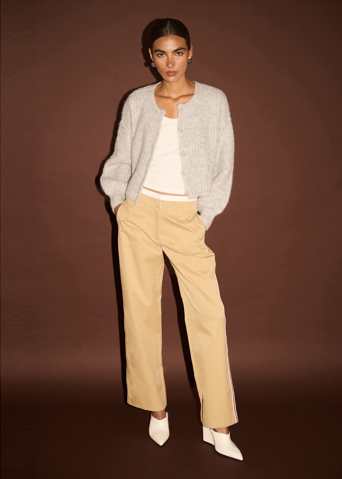 Angled view of the Beige Striped Contrast Waist Pants with a full-length design and a contrast white waist band.