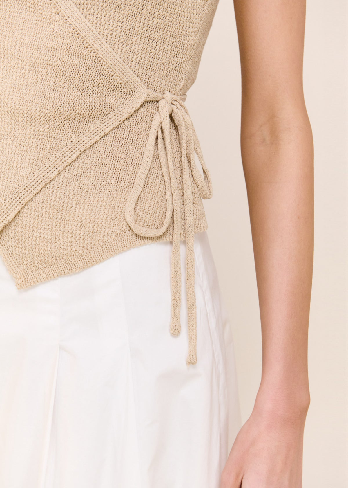 Close-up detail of the Beige V-neck Wrap Knit Top, showing back waist tie.