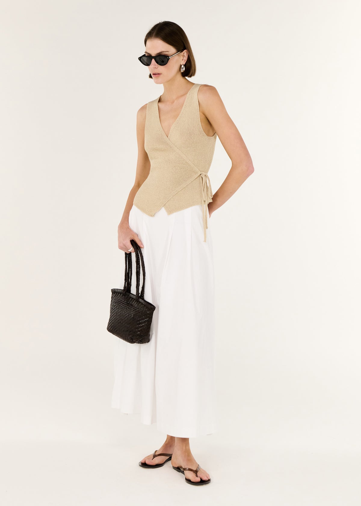 Side view of the Beige V-neck Wrap Knit Top, showing an adjustable side tie closure and a soft knit texture.