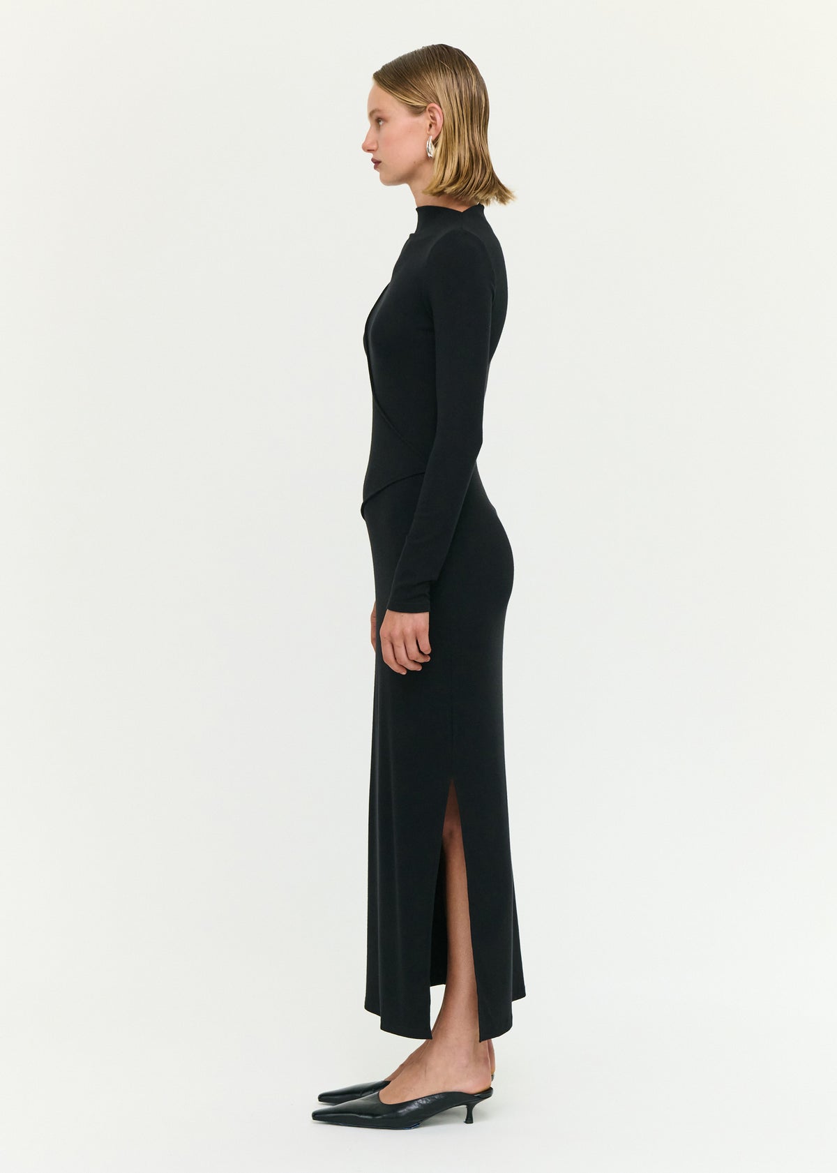 Side view of the Black Asymmetric Seam Detail Midi Dress, showing a midi length and a side split.