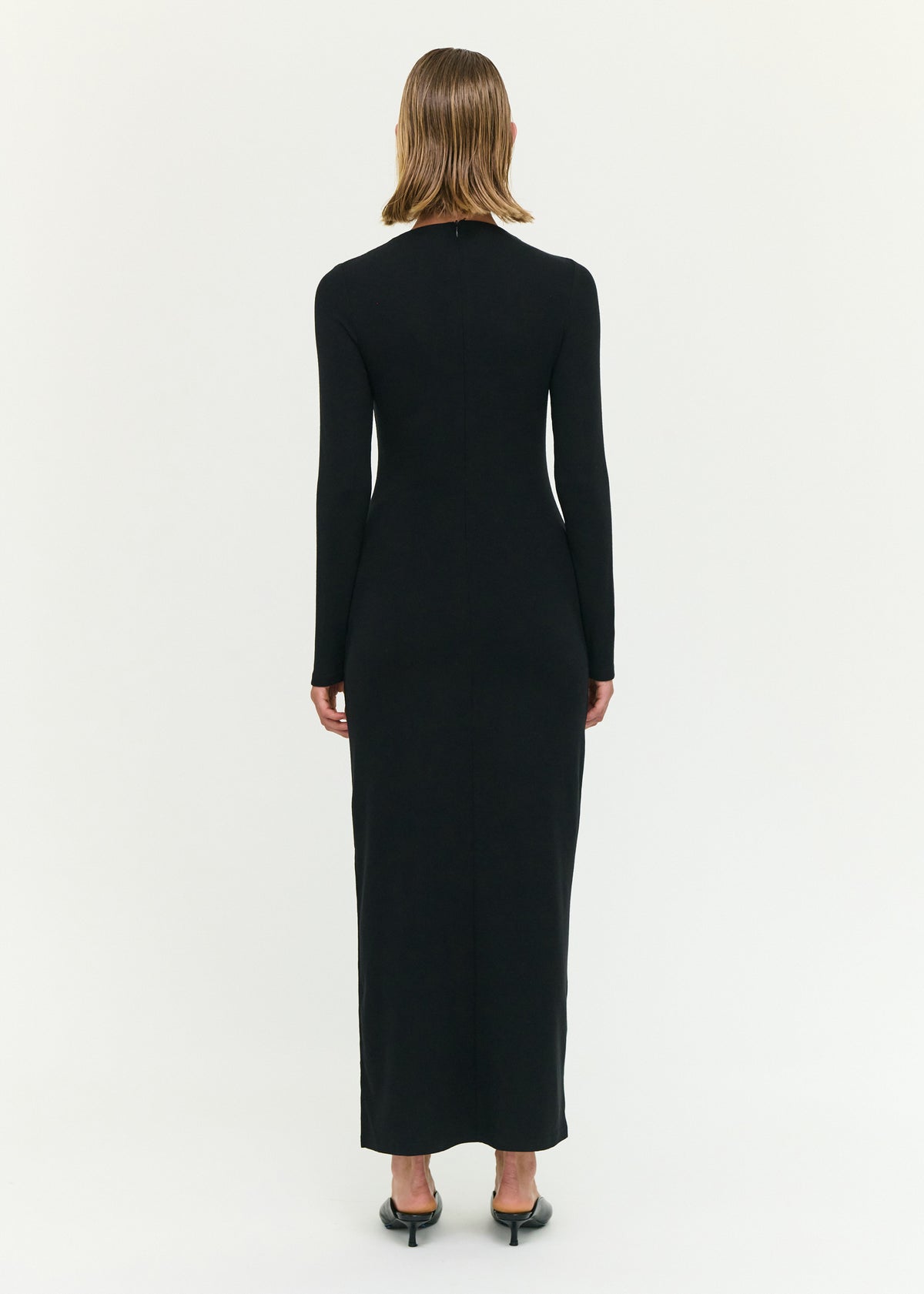 Back view of the Black Asymmetric Seam Detail Midi Dress with a soft stretch knit fabrication and a fitted silhouette.