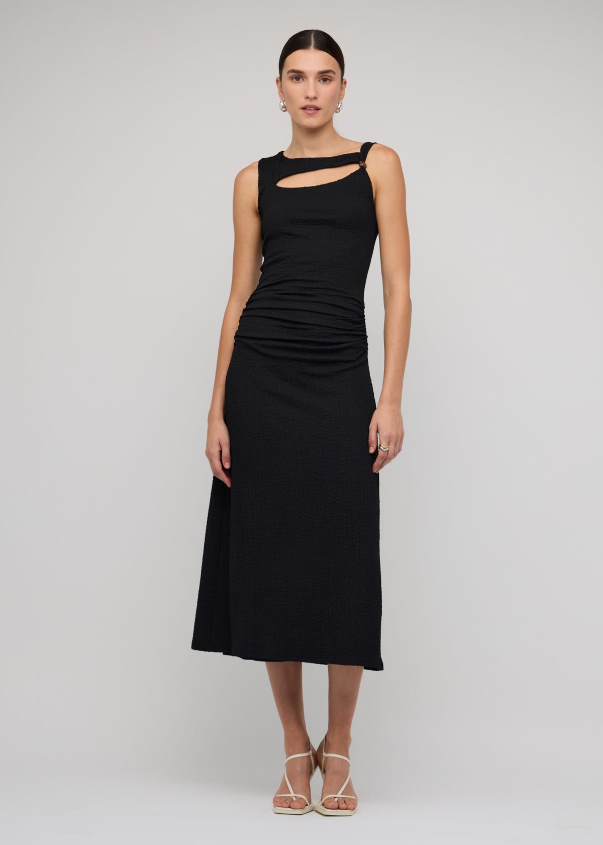 Model wearing Black Cut Out Ruched A-Line Midi Dress With Bead Detail with a black and an asymmetric neckline with cut-out detail.