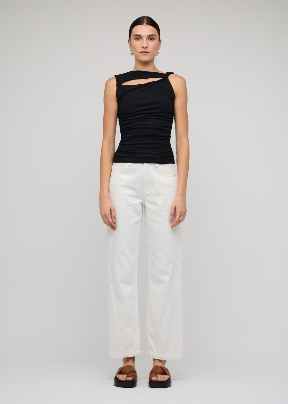 Model wearing Black Cut Out Ruched Top With Bead Detail with a sleeveless cut and ruched sides.