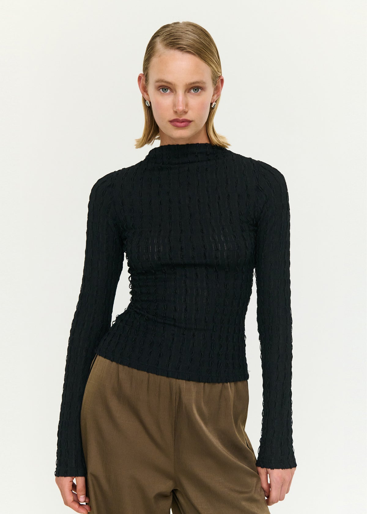 Close-up of the Black High Neck Crinkle Stitch Top, showing a high neckline and long sleeves.