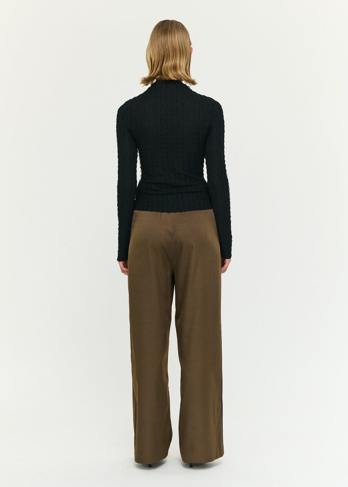 Back view of the Black High Neck Crinkle Stitch Top with a textured stretch fabrication and a high neckline.