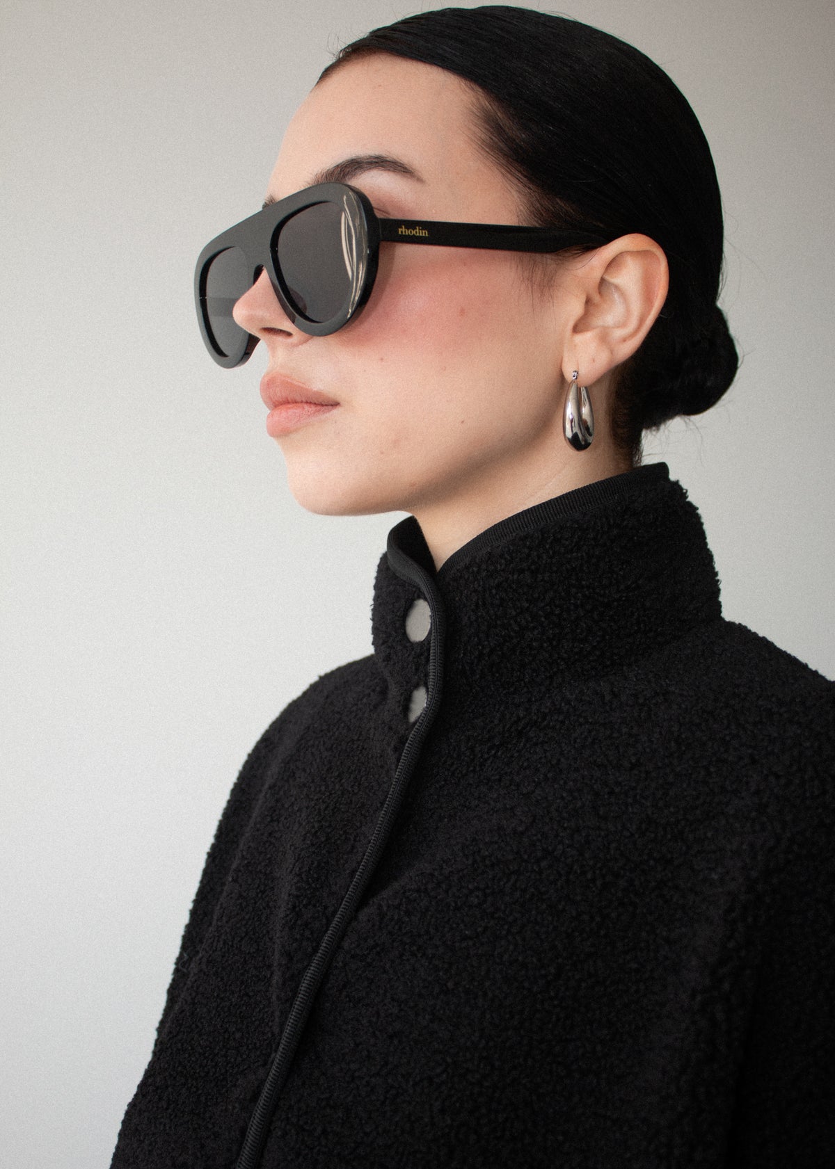 Close-up detail of the Black High Neck Cropped Sherpa Jacket, showing stand collar.