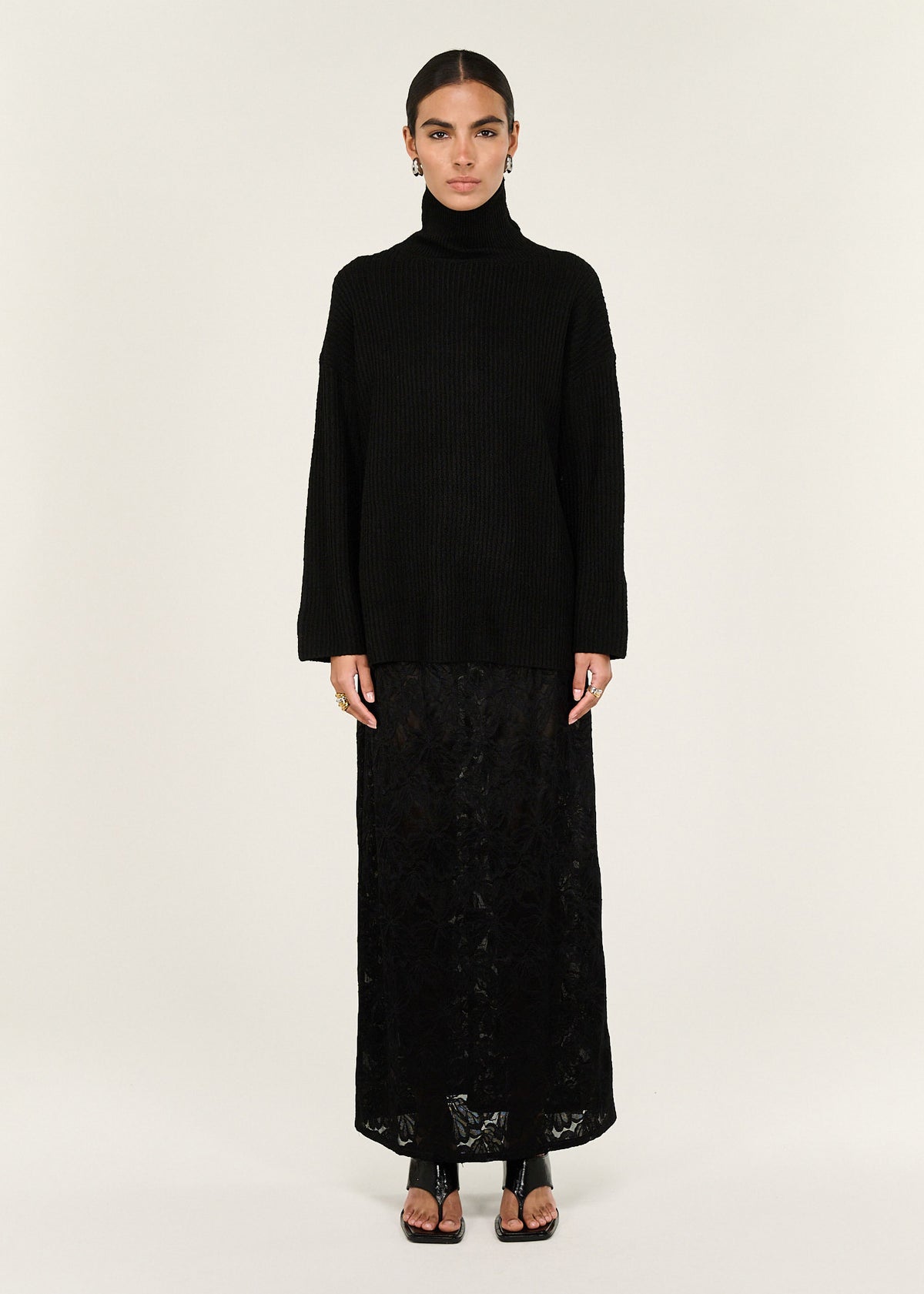 Model wearing Black Roll Neck Oversized Knit Jumper with a roll neck neckline and a relaxed fit.