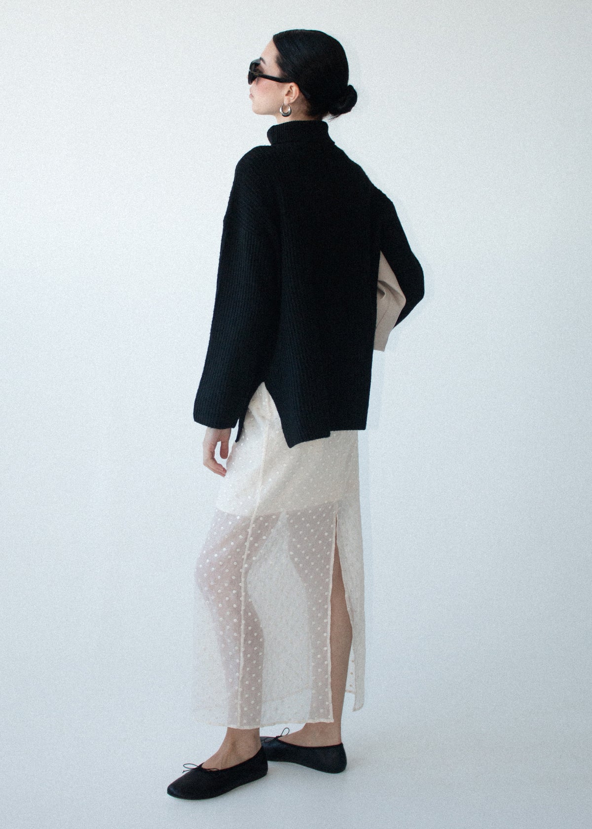 Back view of the Black Roll Neck Oversized Knit Jumper with a roll neck neckline and a relaxed fit.
