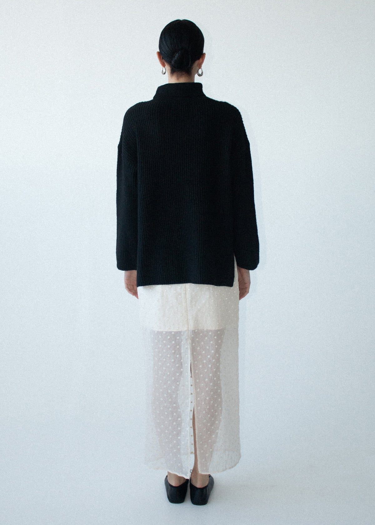 Back view of the Black Roll Neck Oversized Knit Jumper, showing a roll neck neckline and a relaxed fit.