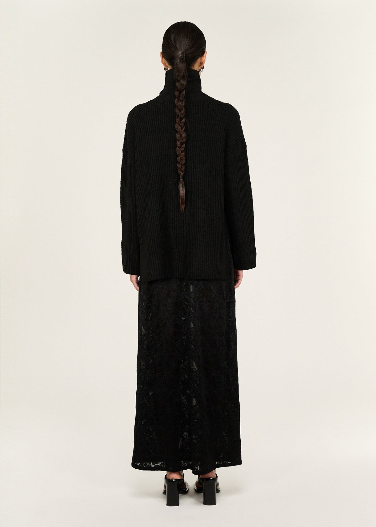 Back view of the Black Roll Neck Oversized Knit Jumper with a relaxed fit and a roll neck neckline.