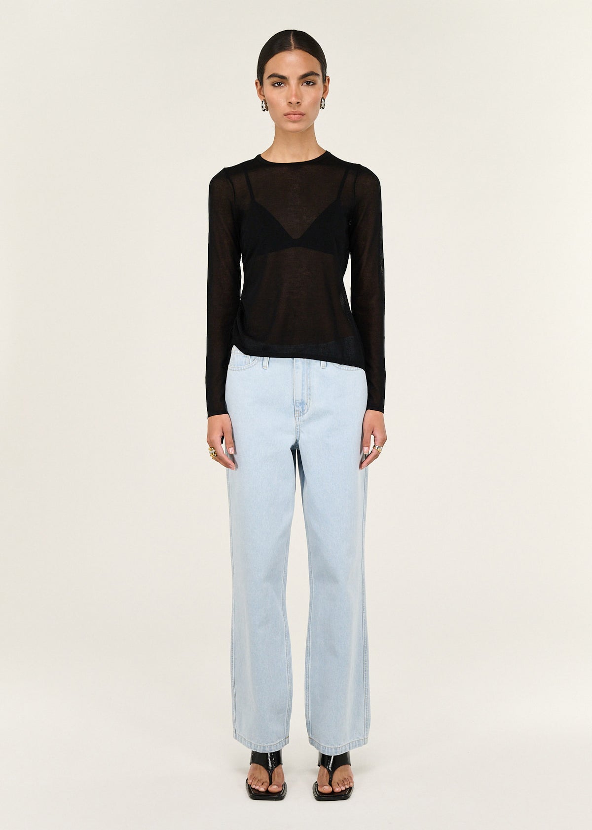 Model wearing Black Ruched Detail Sheer Knit Top with a sheer knit fabrication and a fitted silhouette.