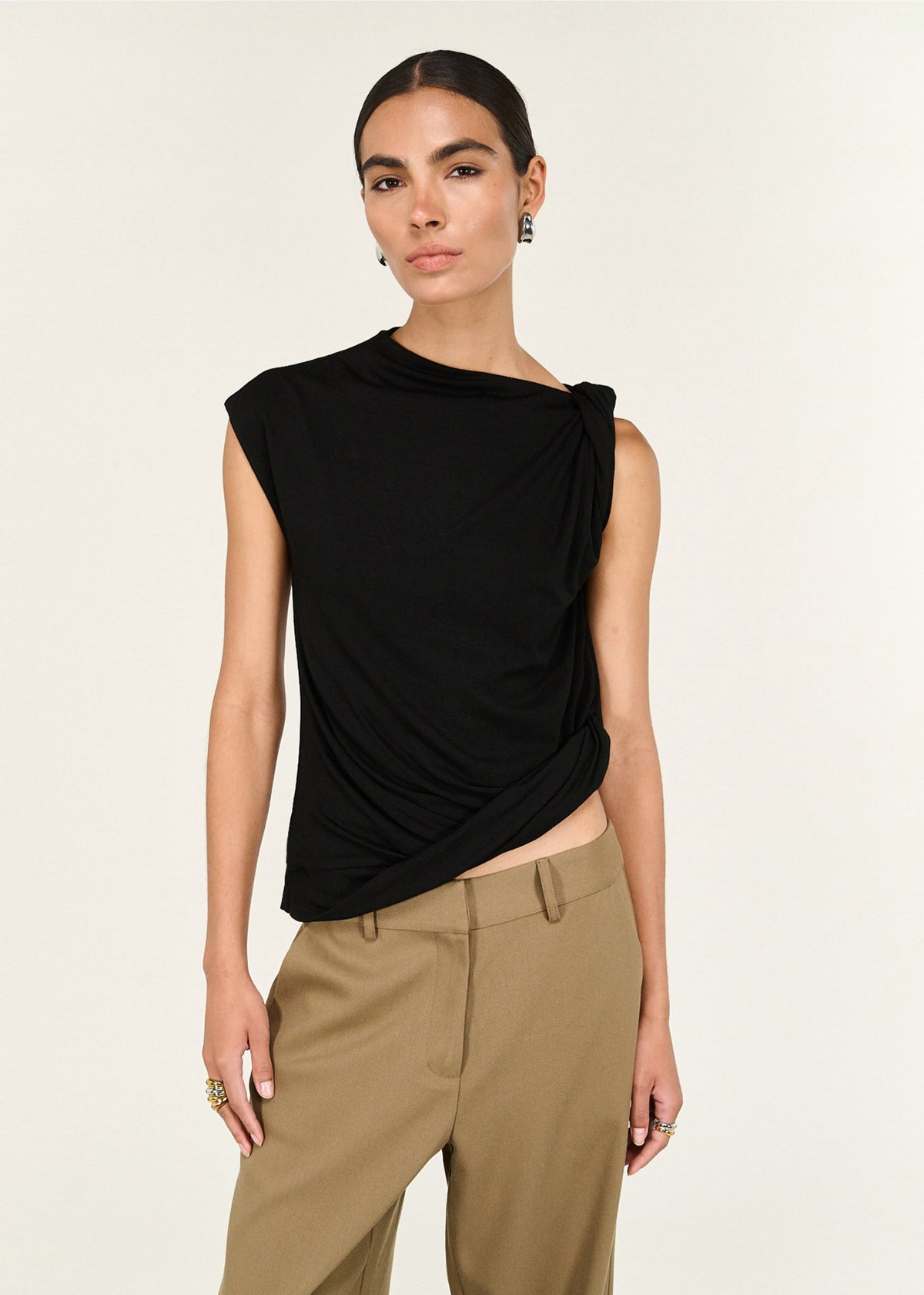 Close-up of the Black Twist Asymmetric Tank, showing a high neckline and a shoulder twist detail.