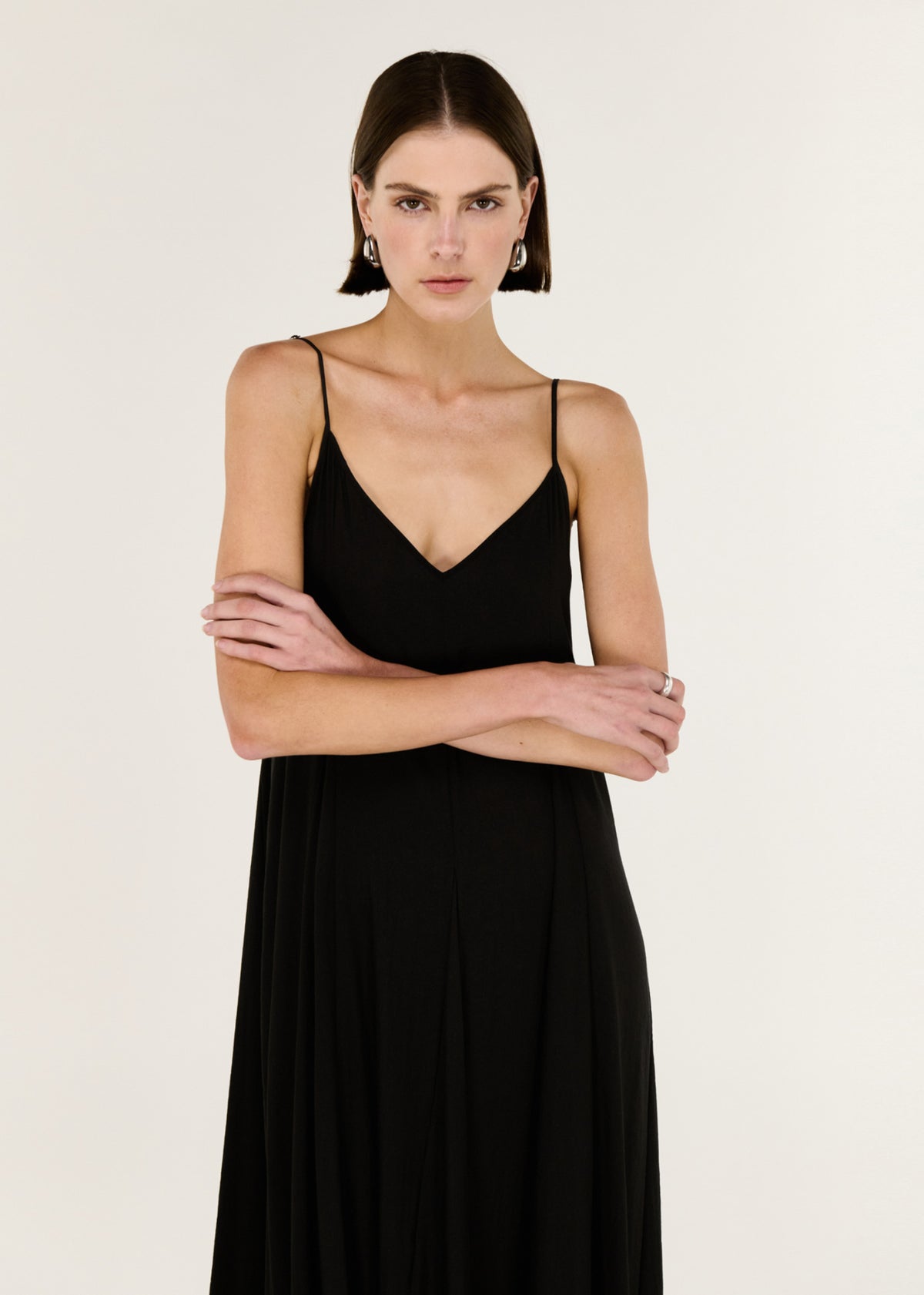 Close-up of the Black V-Neck Floaty Maxi Dress, showing a deep V neckline and thin adjustable straps.