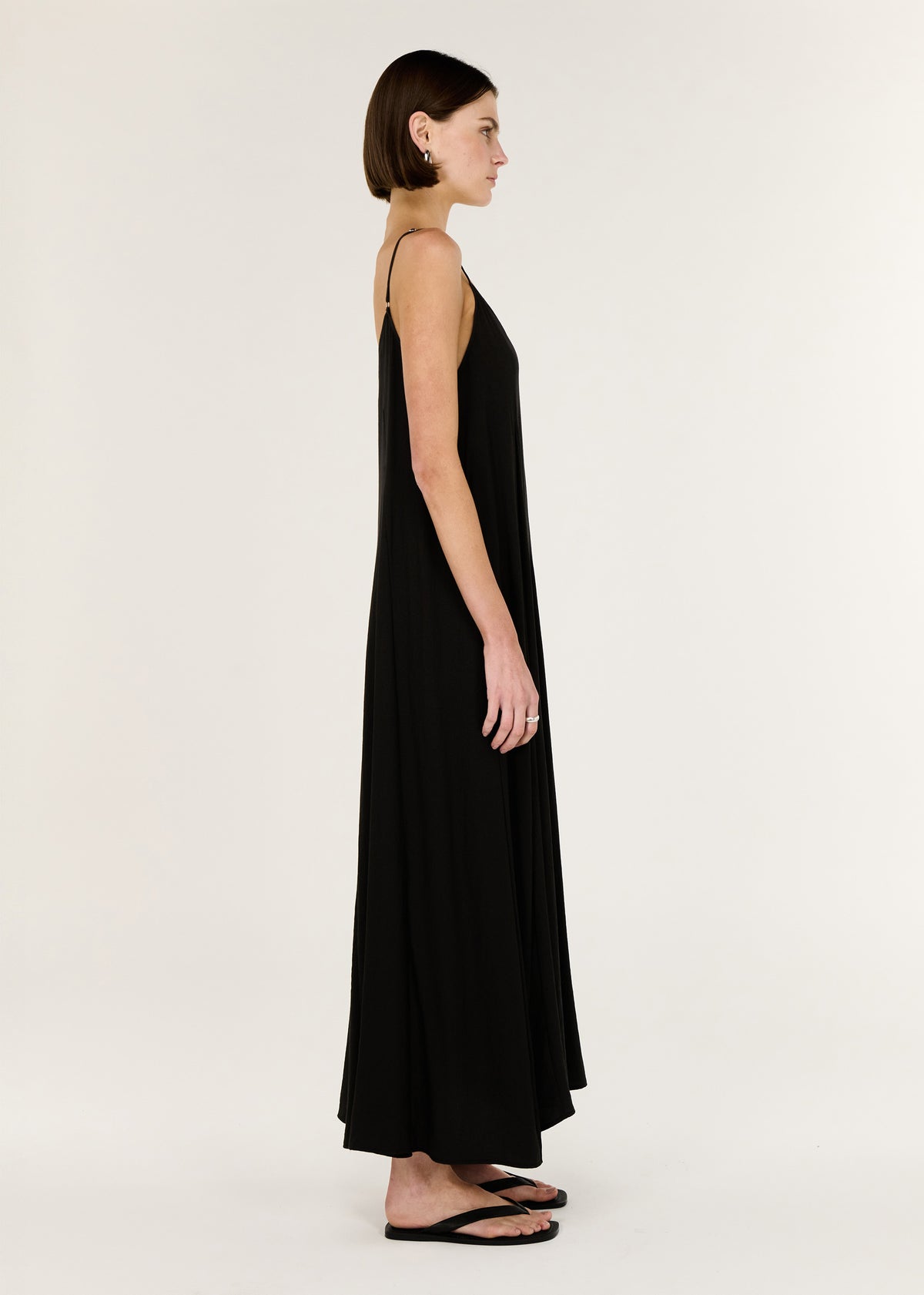 Side view of the Black V-Neck Floaty Maxi Dress, showing a relaxed fit and a maxi length silhouette.