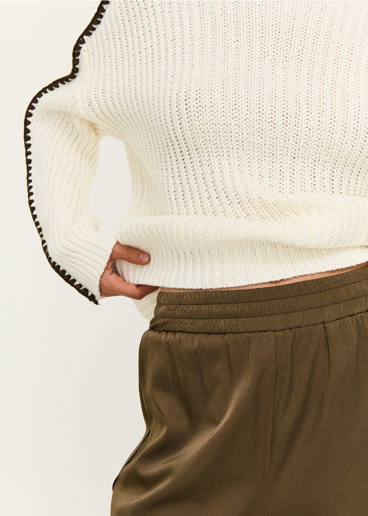 Close-up detail of the Blanket Stitch Detail High Neck Jumper, showing cuff stitching.