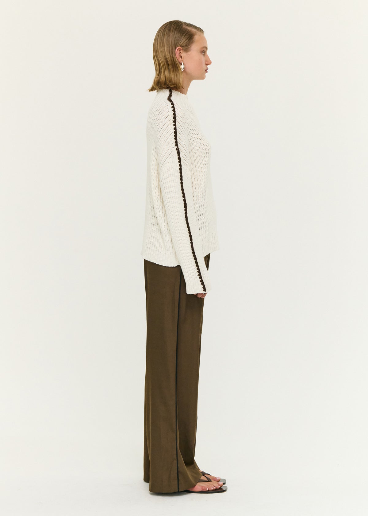 Back view of the Blanket Stitch Detail High Neck Jumper with a chunky rib knit fabrication and an oversized fit.