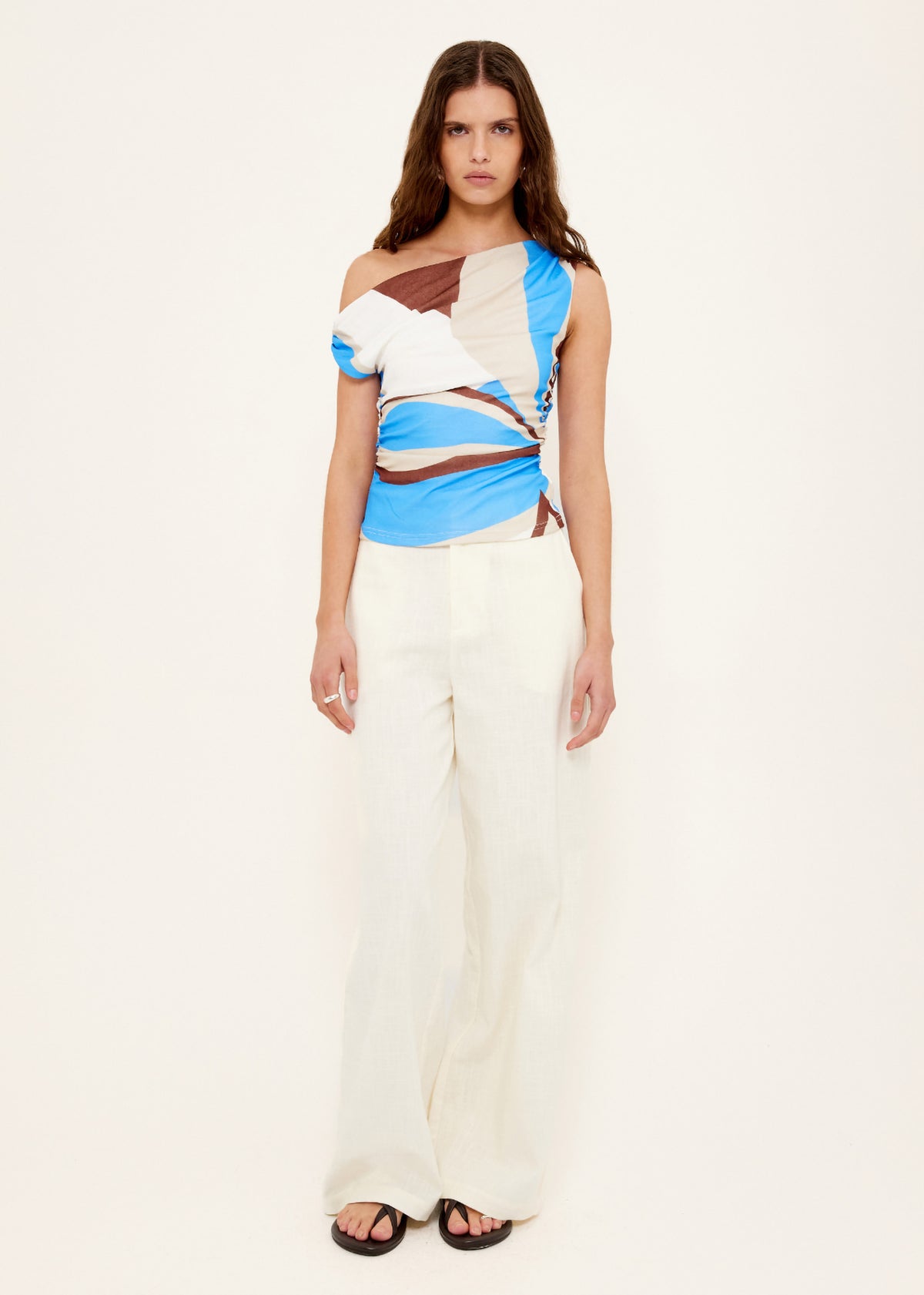 Model wearing Blue Abstract Asymmetric Mesh Top with an abstract print exclusive to Staple the Label and a fully lined.