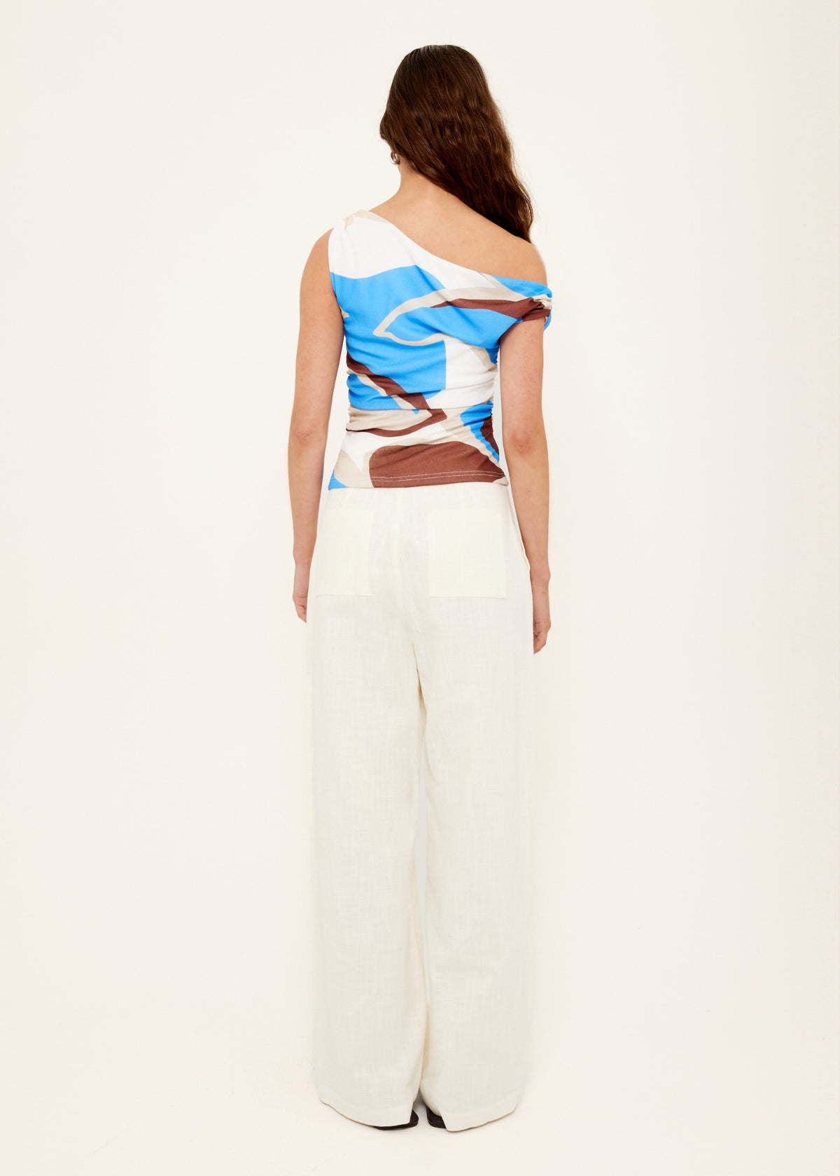 Back view of the Blue Abstract Asymmetric Mesh Top with a one-shoulder asymmetric neckline and a stretch mesh fabric.