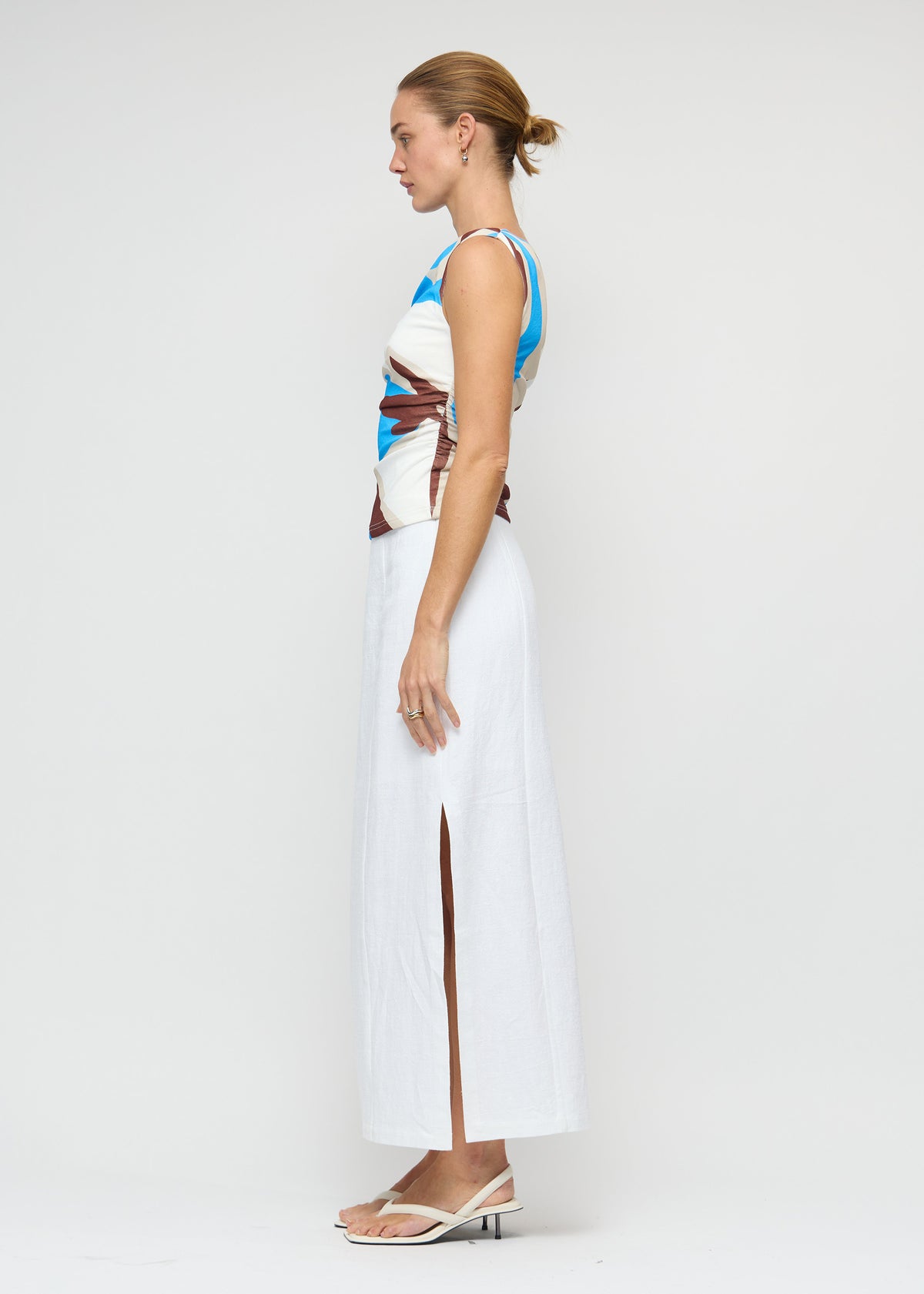 Side profile of the Blue Abstract Asymmetric Mesh Top with an abstract print exclusive to Staple the Label and a fully lined.