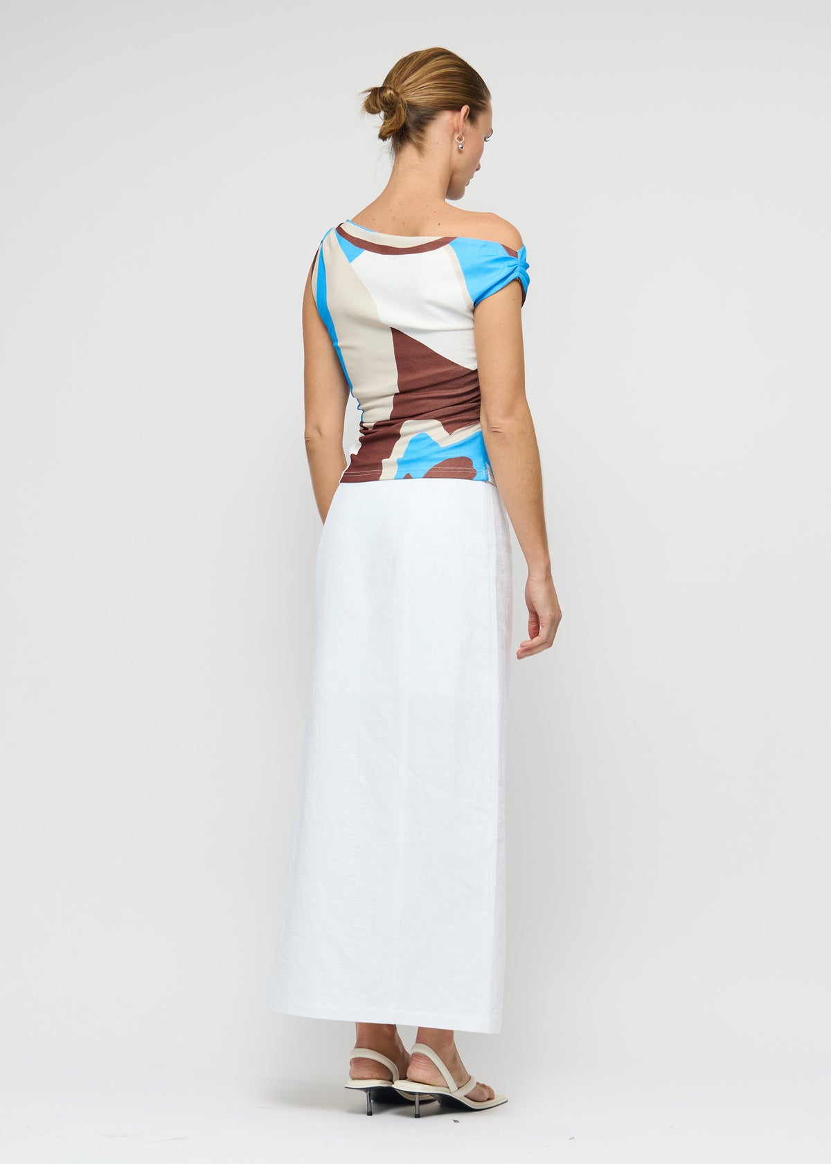 Back view of the Blue Abstract Asymmetric Mesh Top with a stretch mesh fabric and a one-shoulder asymmetric neckline.