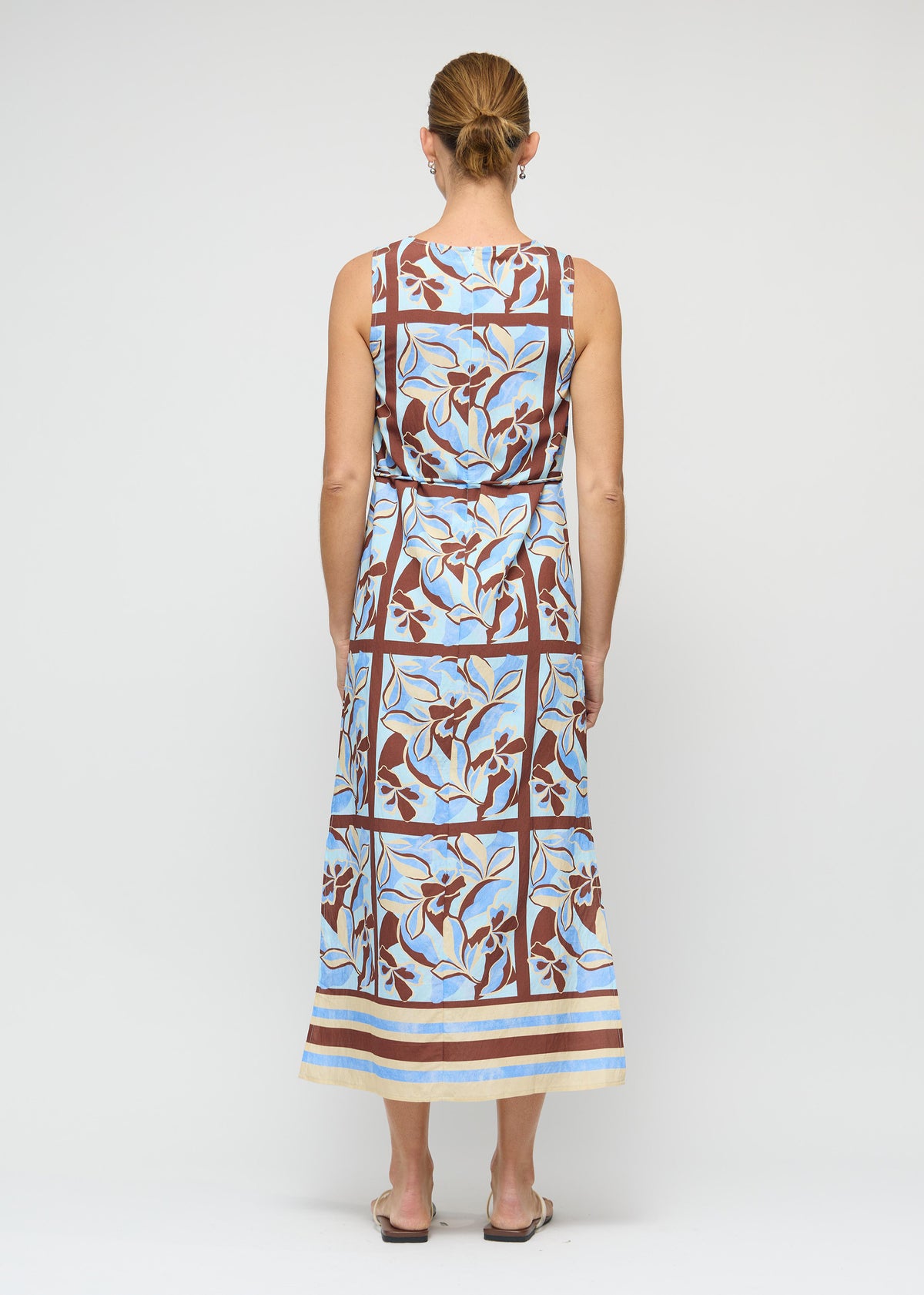 Back view of the Blue Abstract floral Midi Dress with Tie Waist with a sleeveless, high-neck silhouette and a midi length.