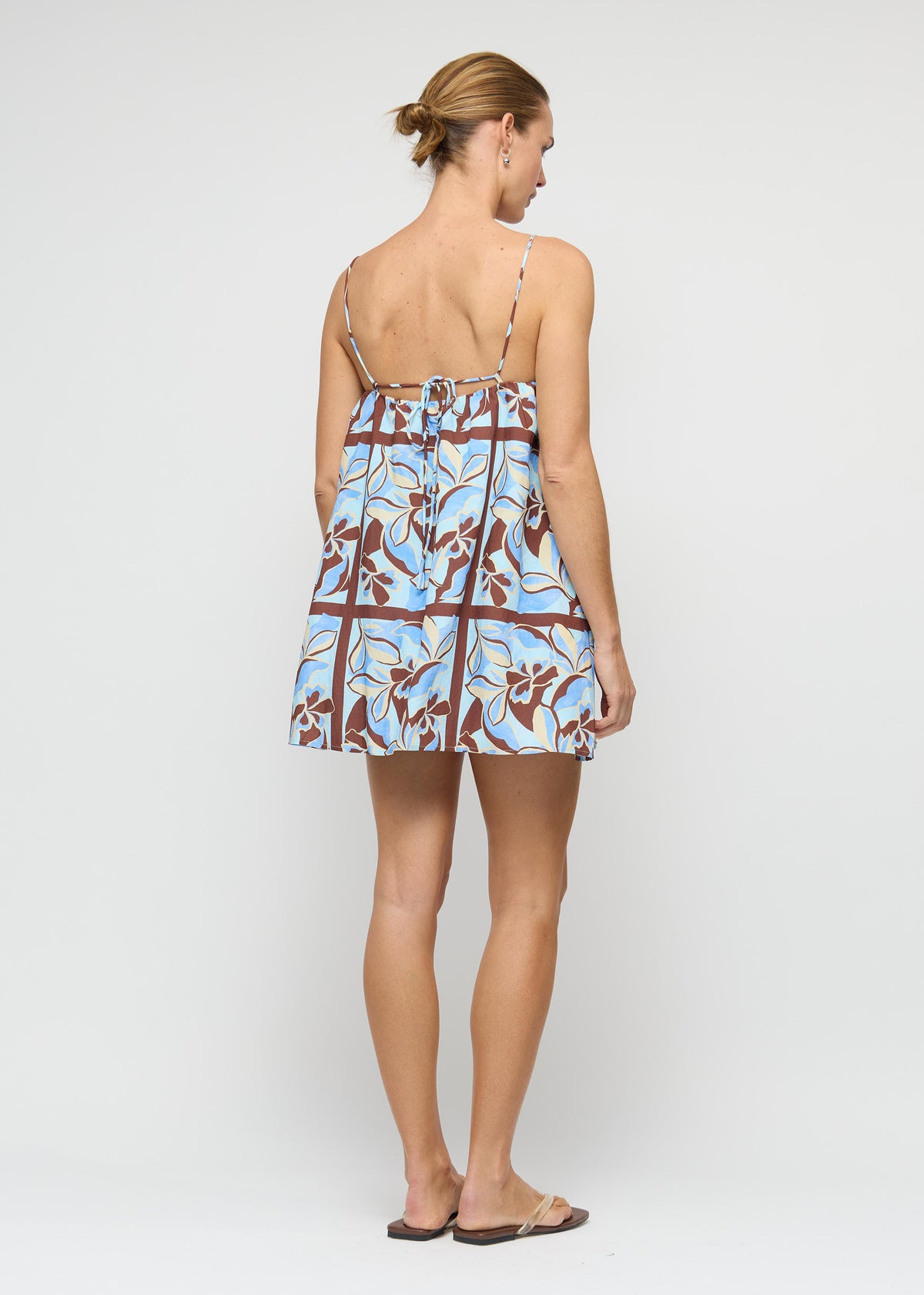 Back view of the Blue Abstract floral Mini Dress with a relaxed trapeze silhouette and a gathered neckline.