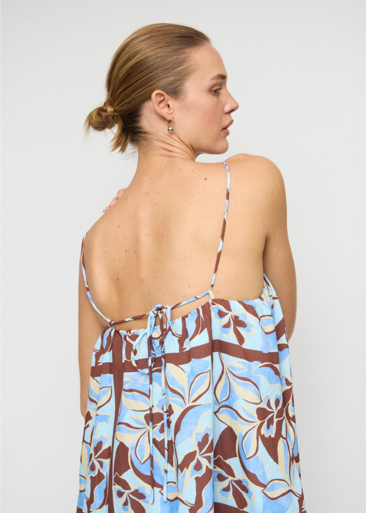 Close-up detail of the Blue Abstract floral Mini Dress, showing open strappy back.